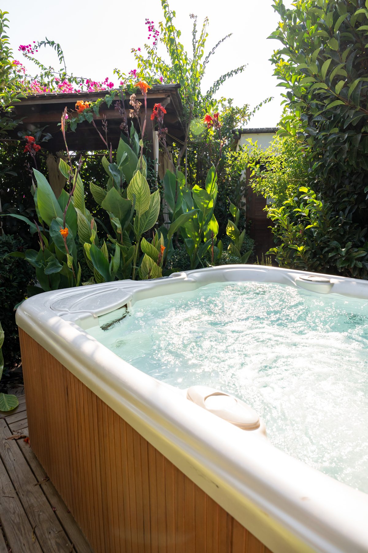 Outdoor hot tub among the plants